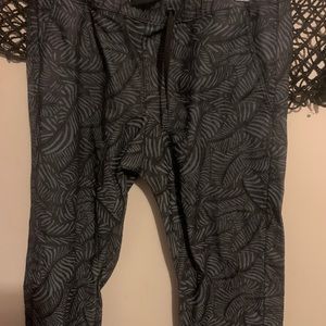Black joggers with black designs and Red and gray camo pants